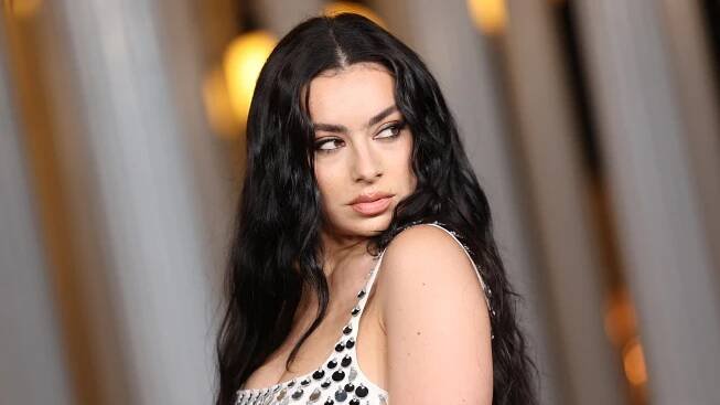 Charli XCX Is an Indie Sleaze Inspiration in a Stained Tank Top, Jorts, and $3,000 Boots