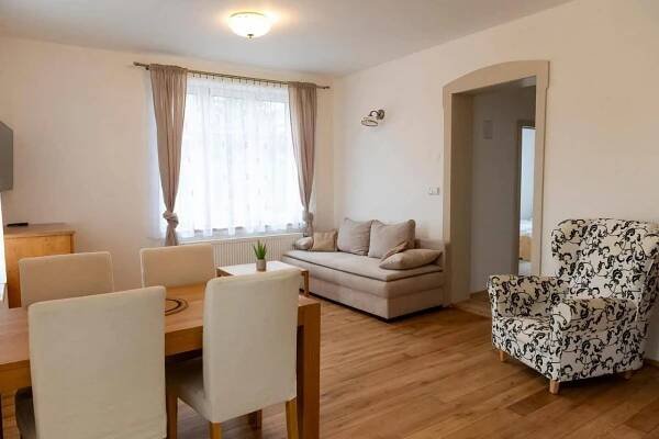 a living room with a table and chairs and a couch at Penzion 1914 in Rádlo +26 photos