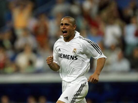 Roberto Carlos of Real Madrid celebrating a goal.