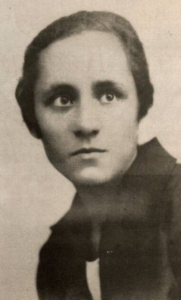 A vintage portrait of a person with short hair, wearing a collared shirt, looking slightly to the side with a serious expression