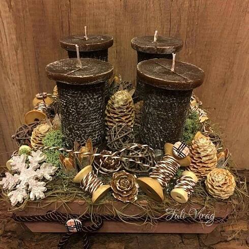 two candles are sitting on top of some pine cones