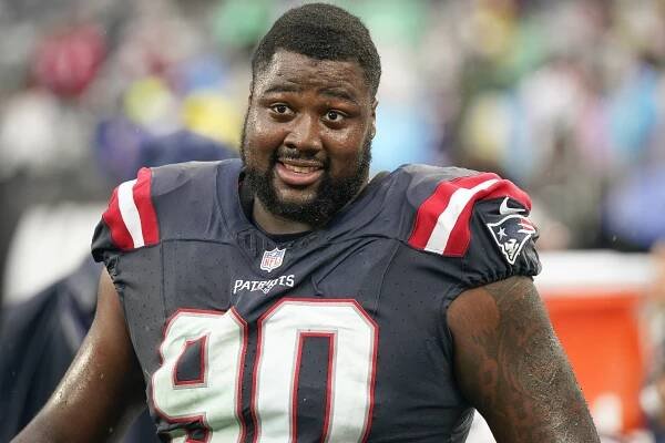 Patriots defensive tackle Christian Barmore, who was diagnosed with blood clots over the weekend, stands on the sideline during an NFL football game against the New York Jets on Sunday Sept. 24, 2023,