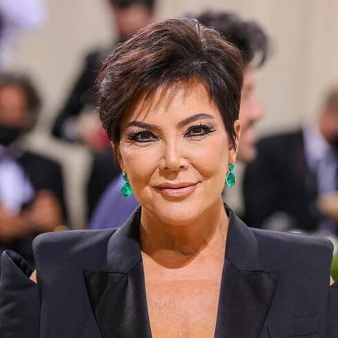 Kris Jenner wears a voluminous pixie haircut with subtle chocolate highlights