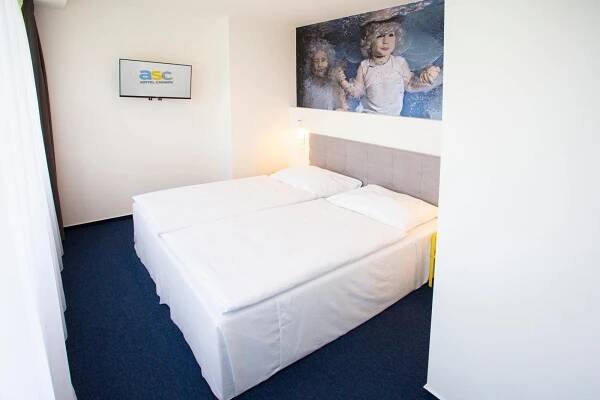 Postel nebo postele na pokoji v ubytování Hotel CHODOV ASC