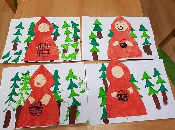 four children's artwork made with construction paper