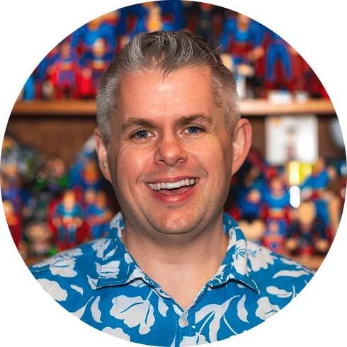 An image of a smiling Jeremy Hill in front of his Superman collection