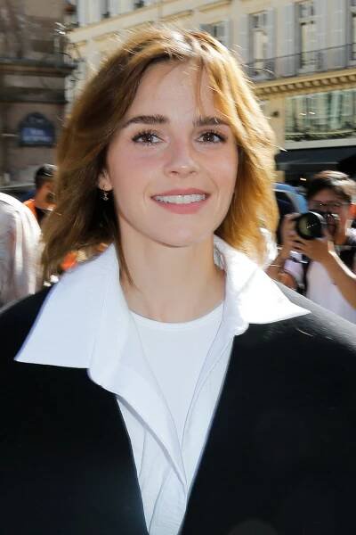 a close up of a person wearing a white shirt and black jacket