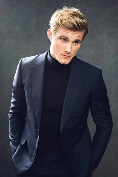 a man in a black suit and turtle neck sweater is posing for a photo with his hands on his hips