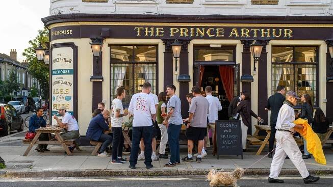 People standing outside a pub