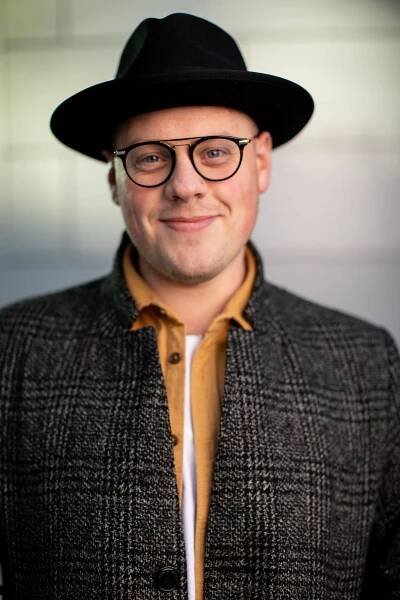 male with glasses and black hat 