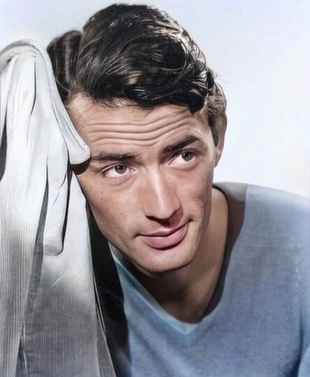 a man is holding his head up and looking at the camera