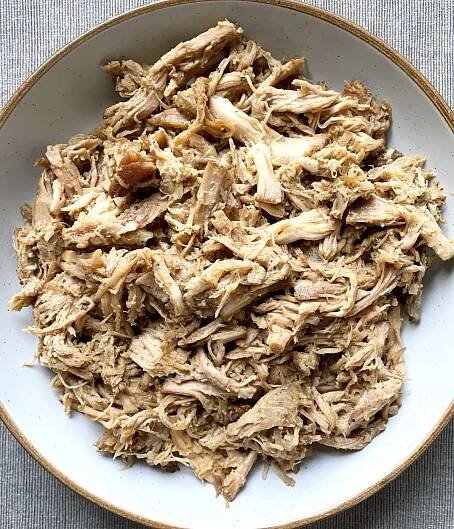 A round dish containing pulled pork.