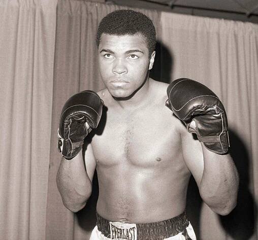 Muhammad Ali wearing boxing gloves in 1967.