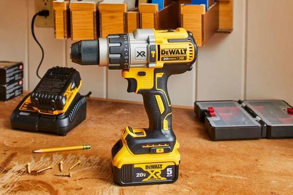 DEWALT XR DCD996P2 20-Volt Hammer Drill Drill placed on table with screws
