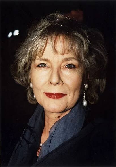 an older woman with grey hair and red lipstick