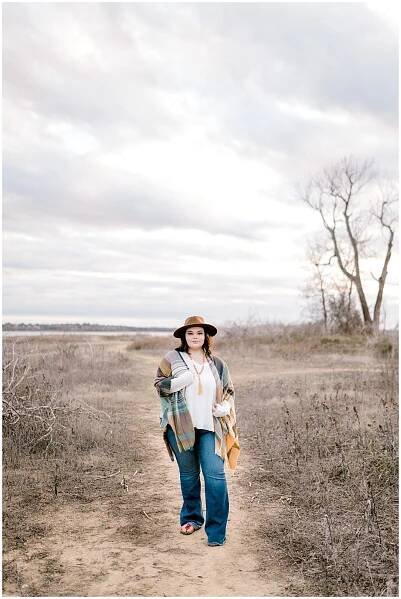 Girl standing in land next to beach for 2020 senior session