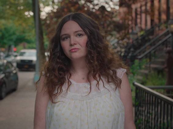 Megan Stalter wearing a nightgown in Too Much.