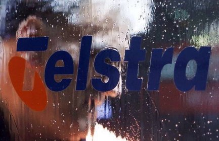 A worker cleans up a Telstra public phone in central Sydney