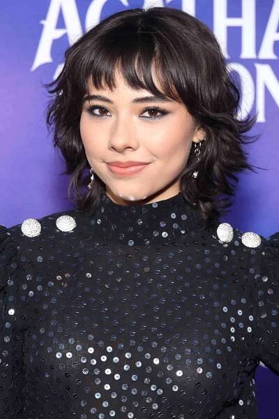 Xochitl Gomez with a shaggy messy bob haircut with bangs