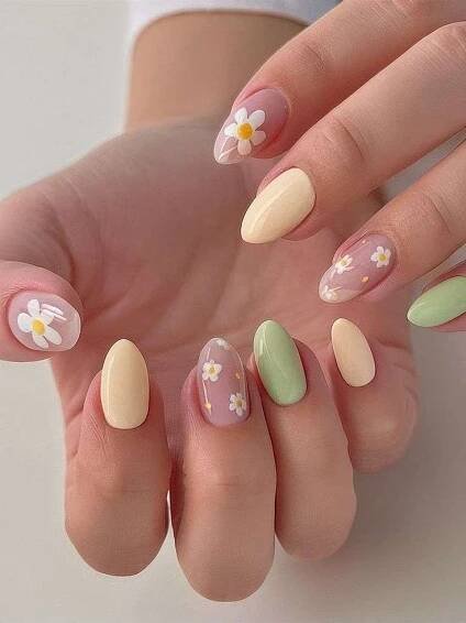 Let’s dive into this gorgeous nail look—I’m obsessed with the soft pastel vibes we’ve got here! The mix of creamy beige, mint green, and baby pink with delicate daisy accents screams springtime chic, making it a must-try for your next luxury nail art moment.