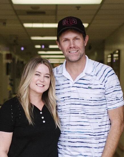 Jennifer and Peter standing together in a hallway