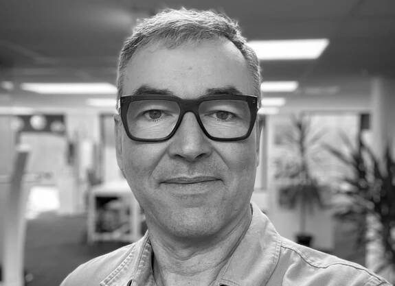 John Moore black and white profile photo.