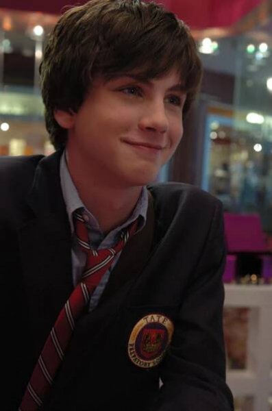 a young man wearing a suit and tie
