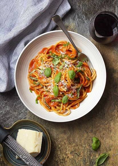 For an authentic Italian dinner, try my pasta al pomodoro! Spaghetti is tossed with a simple and delicious San Marzano tomato sauce and topped with basil and Parmesan in this easy recipe. | justalittlebitofbacon.com #italianrecipes #pastarecipes #easydinner #italian #spaghetti #pasta #tomatosauce