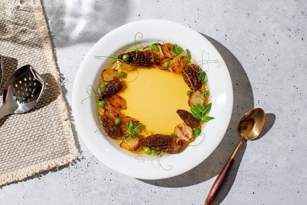 Nina Compton Chicken Consommé and Spring Vegetables made with All-Clad