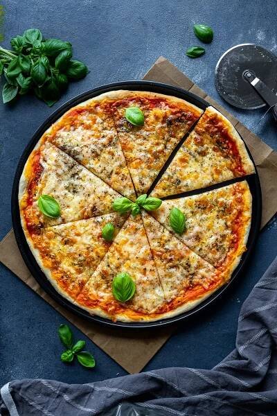 Overhead shot of Easy Cheese and Tomato Pizza, cut into slices.