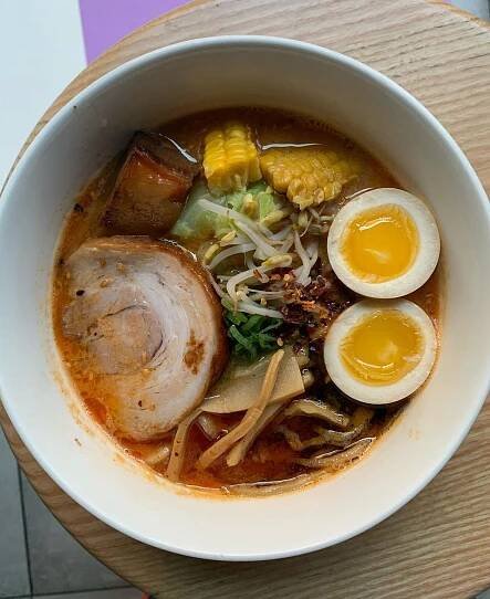 a bowl of ramen with pork, eggs, and corn from Casa Ramen in milan