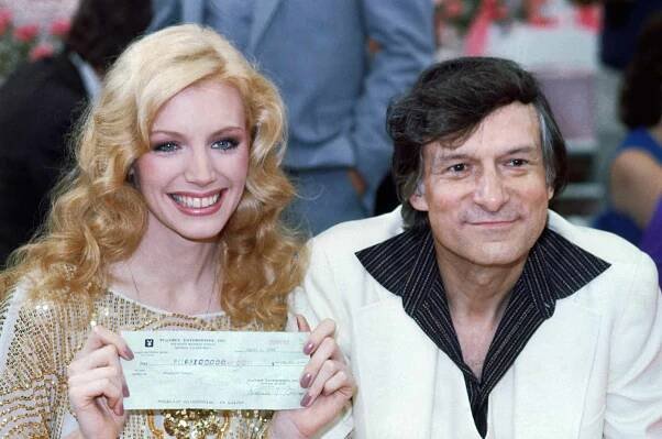 Shannon Lee Tweed, holding check, with Hugh Hefner at the Playmate of the Year party.