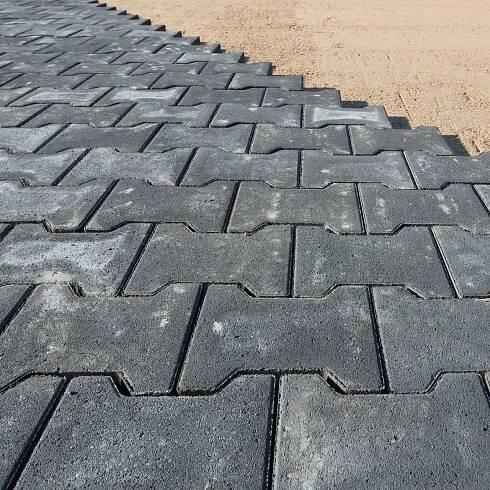 a row of gray bricks are laying on the ground