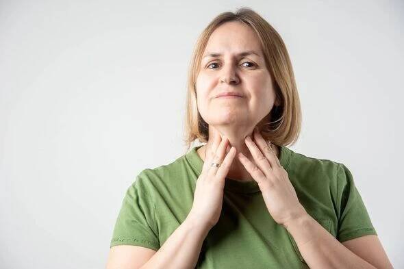 Sore throat woman on gray background