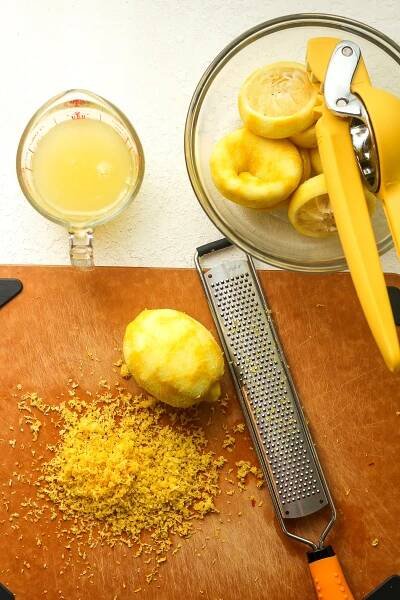 Overhead view of some zested and juiced lemons.