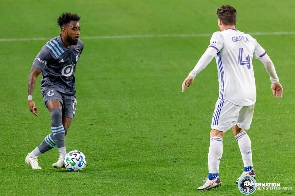 October 3, 2020 - Saint Paul, Minnesota, United States - Minnesota United defender Romain Metanire (19) passes the ball past FC Cincinnati defender Greg Garza (4) during the match at Allianz Field. 
