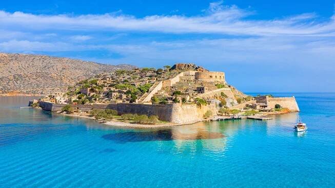 View of historic Spinalonga Island fortress with turquoise waters