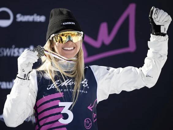 Danielle Scott holds up her world championships bronze medal.