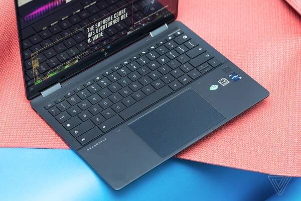 The keyboard of the HP Elite Dragonfly Chromebook seen from above. The screen displays The Verge homepage.