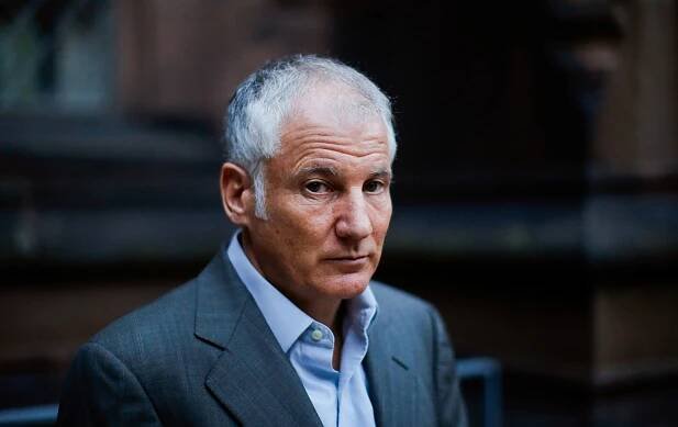 Stephen Kotkin wearing a suit in front of a blurred background.