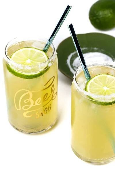 tequila and beer cocktails with lime wheels for garnishes