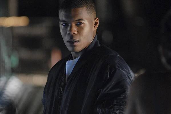 A teenage boy, Gaius Charles as Smash Williams, on the set of "Friday Night Lights."