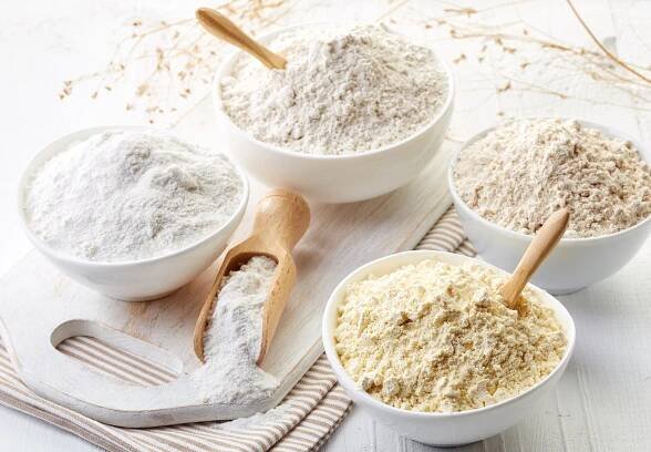 61039776-bowls-of-various-gluten-free-flour-chick-peas-rice-buckwheat-amaranth-seeds-almond-on-white-wooden-b