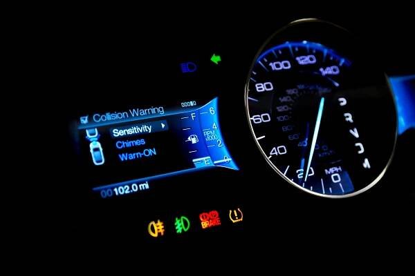 Dashboard and digital display of a modern car, mileage, fuel consumption, speedometer. New and colorful light indicators isolatred on a black background. Closeup. Miles per hour - MPH.