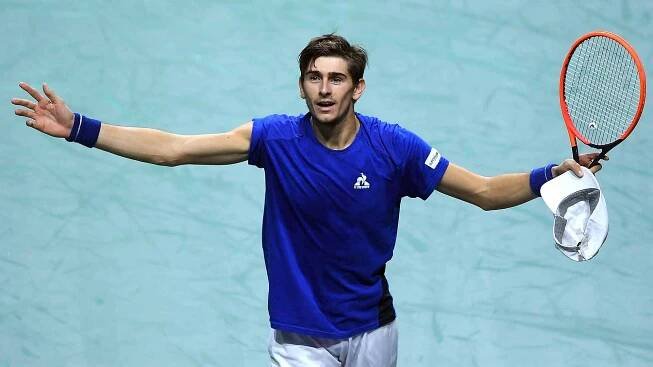 Matteo Arnaldi  celebrates a three-set win over Alexei Popyrin  in the Davis Cup final.