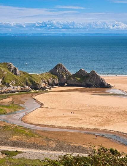Three Cliffs Bay taken from dunes looking out at the Three cliffs and the sea
