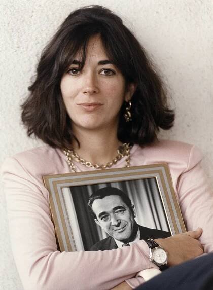 Ghislaine Maxwell holding a framed photo of her father.