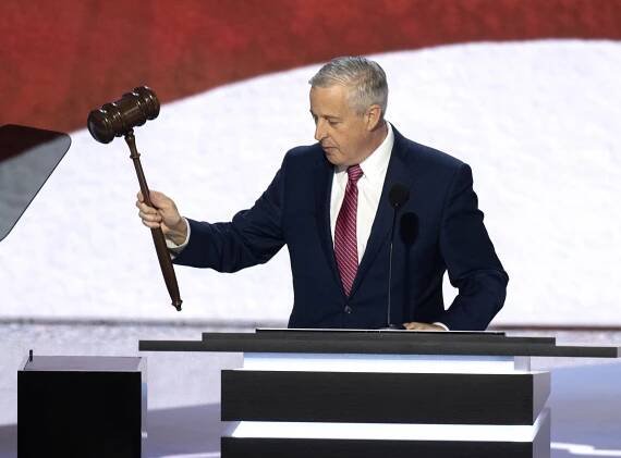 A man in a suit calls the 2024 Republican National Convention to order with a gavel.