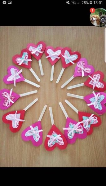 heart shaped lollipops are arranged in a circle on a table with toothpicks