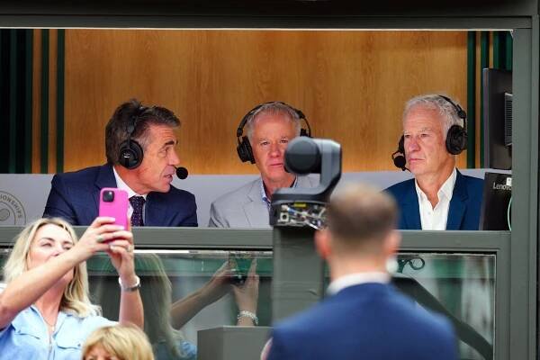 John McEnroe and Patrick McEnroe commentating on a tennis match.